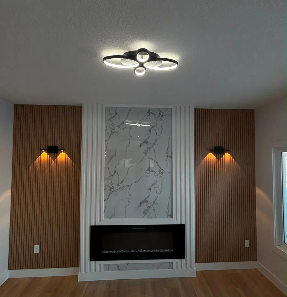 Fireplace wall with a veined centre panel, vertical wood-toned slats and warm wall lights